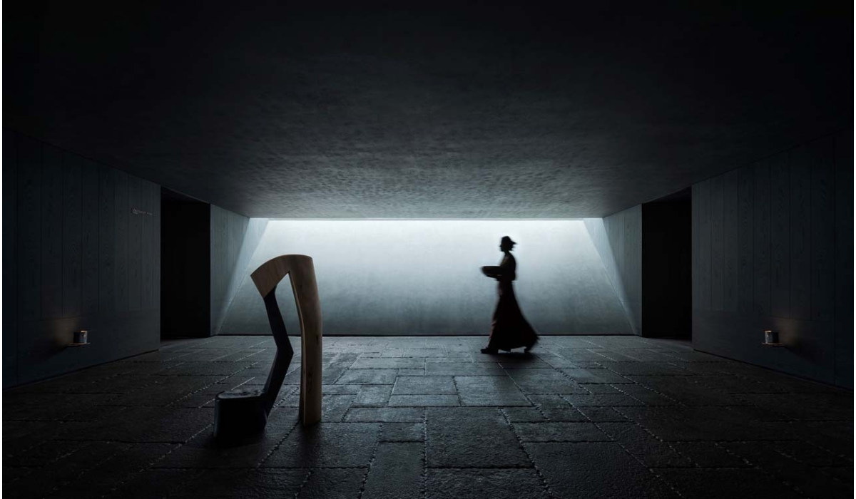 A silhouette of a person walks past modern sculptures in a dimly lit, minimalist space with geometric lighting creating depth.
