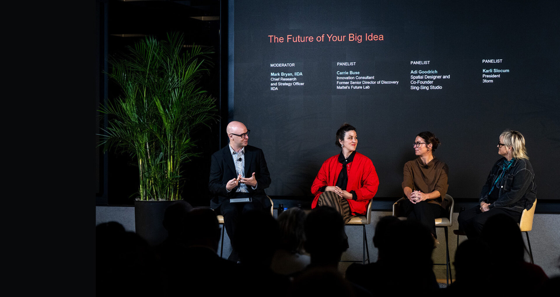 Four panelists seated beneath a screen reading 'The Future of Your Big Idea', moderator on left gestures, woman in red jacket smiles.