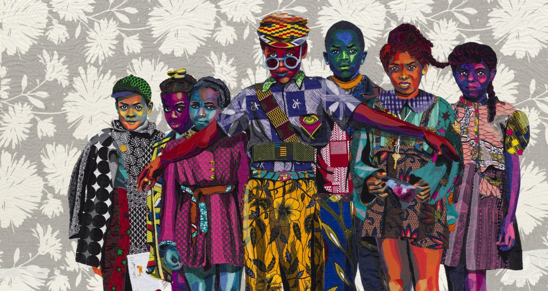 A vibrant group of diverse children pose together, showcasing bold patterns and colors against a floral background. Their expressions convey unity.