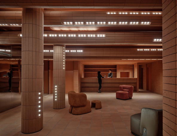 Warm-toned interior featuring textured columns, a reception desk, and stylish seating, creating an inviting atmosphere for guests.