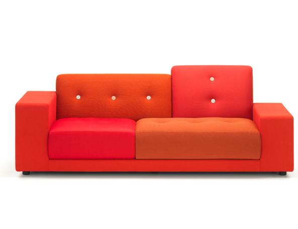 A modern, brightly colored couch featuring a combination of red and orange upholstery with button detailing on the backrest.