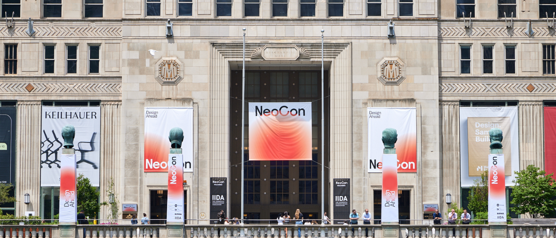 The exterior of the Merchandise Mart features large banners for NeoCon and Keilhauer, showcasing design and architectural themes.