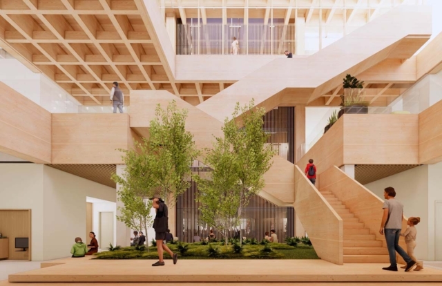 Open multi-level timber atrium with central planted courtyard and young trees, broad wooden staircases, glass railings and people walking.