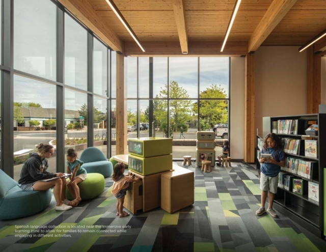 Sunlit children's library with floor-to-ceiling windows, wooden beams, colorful modular seating, play cubes and kids reading and playing.