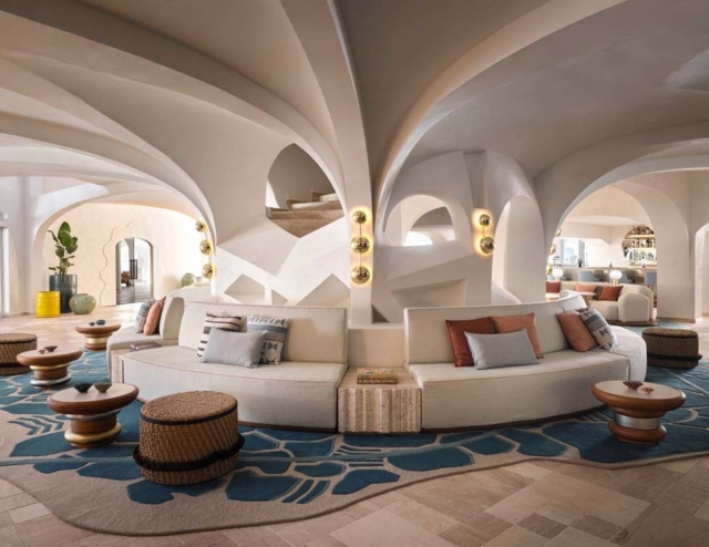 Elegant lounge area featuring curved sofas, unique lighting, and decorative elements, all under beautifully arched ceilings.