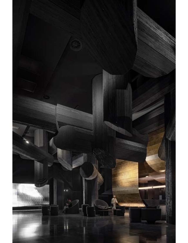 A modern interior space featuring dark wooden beams and unique architectural features, with seating areas and soft lighting.