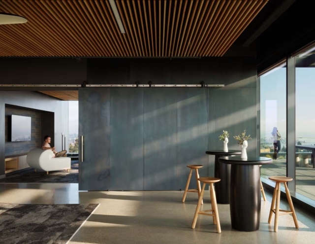 A modern interior features sleek furnishings, large windows, and a minimalistic aesthetic, providing a view of the surrounding landscape.