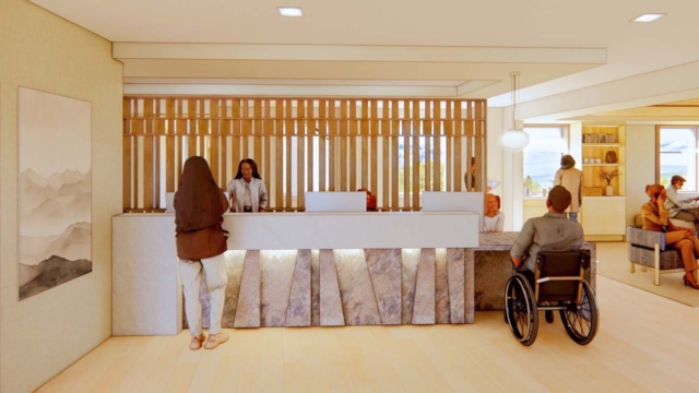 A modern reception area featuring a welcoming front desk, diverse staff, and guests, including a person in a wheelchair, in a bright setting.
