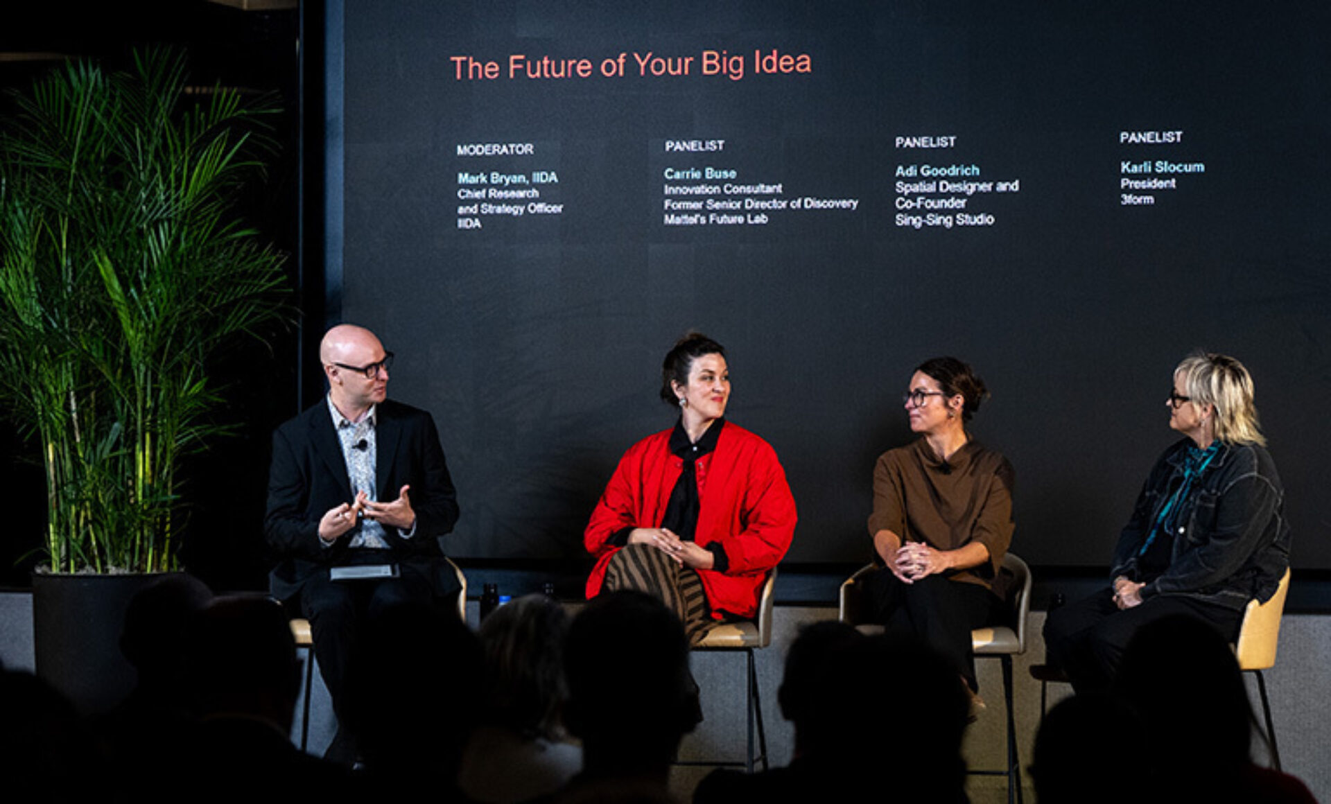 Four panelists seated on stage beneath 'The Future of Your Big Idea' banner: a bald moderator and three women, audience in foreground.